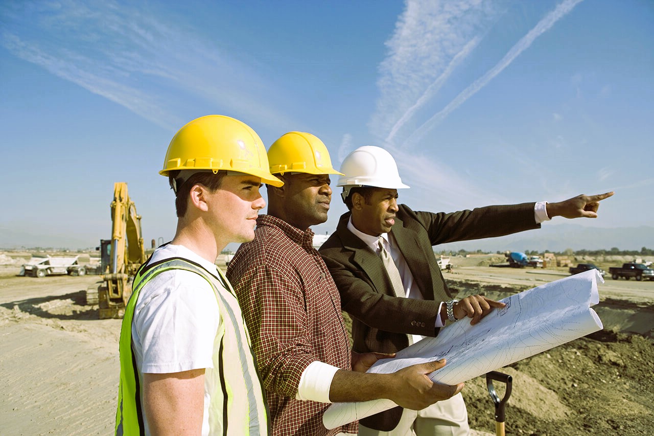 Builders check the construction plan